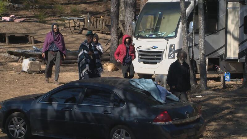 Lando (far right) and his followers at the campsite where authorities executed a search...