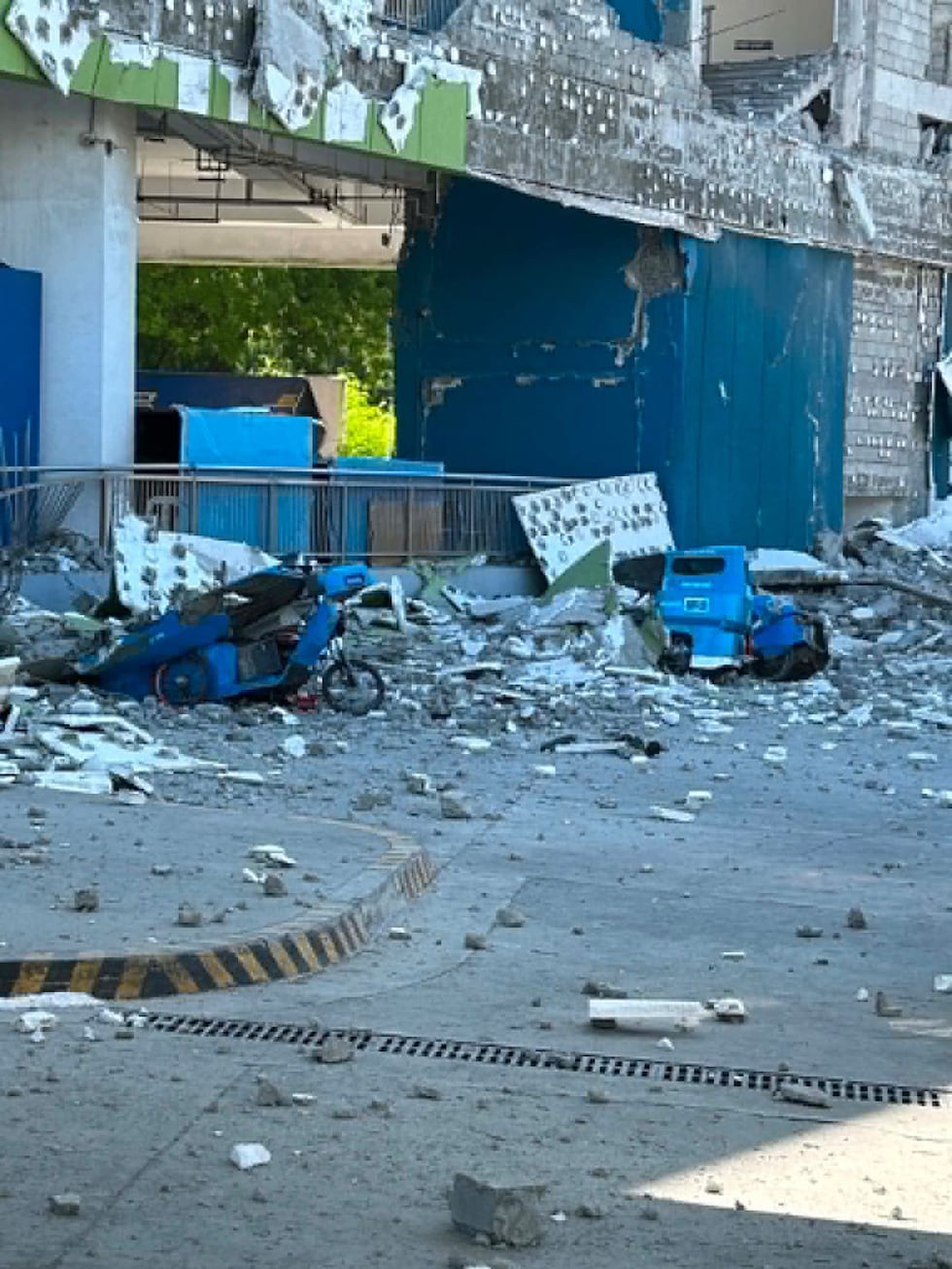 This shows vehicles damaged by debris after powerful earthquake in the Mindanao region,...