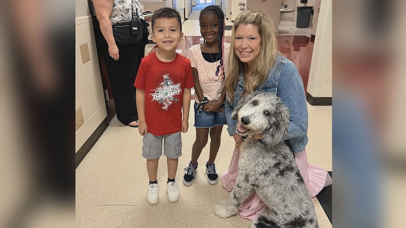College Hills Elementary school students and their principal playing with Koda; their new...