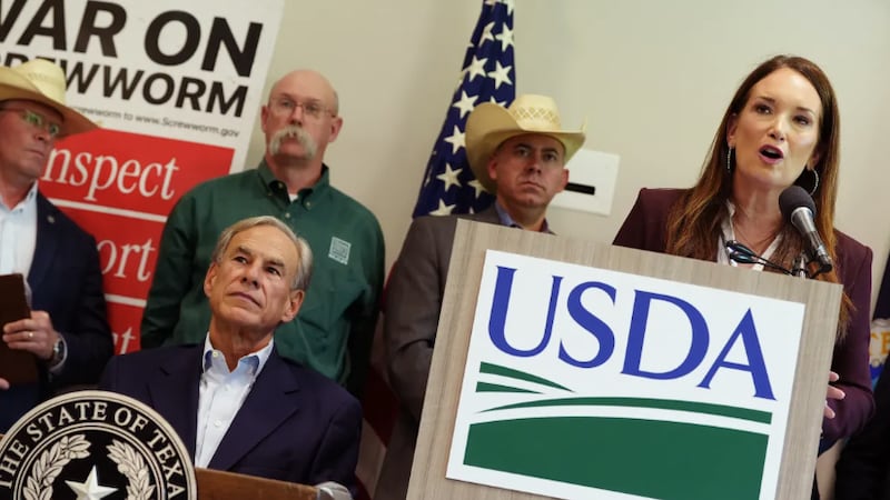 Gov. Greg Abbott listens as U.S. Secretary of Agriculture Brooke Rollins speaks at a presser...
