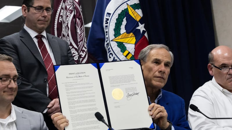 Gov. Greg Abbott signs an emergency declaration related to the New World screwworm at a news...