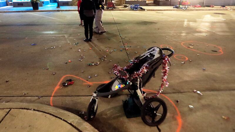 A broken children's stroller lays on W. Main St. in downtown Waukesha, Wis., after an SUV...