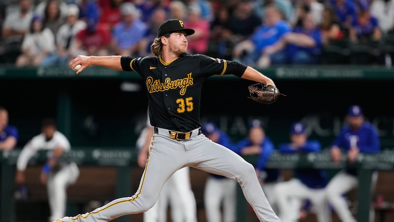 Pittsburgh Pirates pitcher Braxton Ashcraft throws to Texas Rangers' Evan Carter in the fourth...