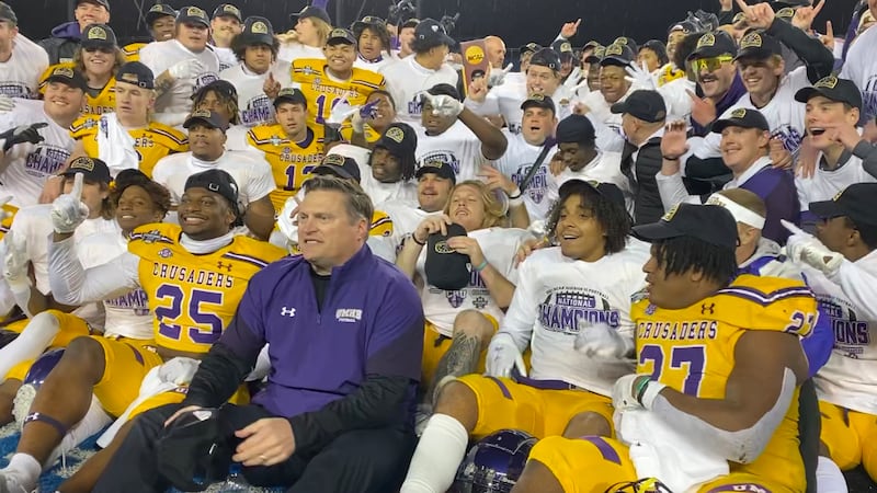 Larry Harmon celebrates with his team after winning the 2021 National Championship